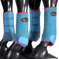 three pairs of horse boots with blue and pink pads on top of each one's feet