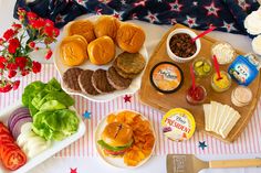 an assortment of food is displayed on a table with red and white striped napkins