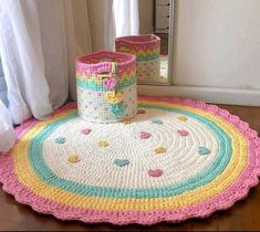 two crocheted baskets sitting on top of a rug