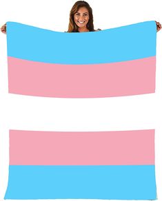 a woman is holding up a large blue and pink striped blanket in front of her face