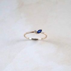 Flower inspired petal ring. Whimsical and dainty. The ring is accompanied by a beautiful blue sapphire in marquise cut and a round brilliant diamond. . . . #sapphire #sapphireengagementring #sapphirering #tinysapphirering #sapphireringsjewelry #jewelryaddict #jewelrylover #giftforher #engagementring Sapphire Ring Minimal, Simpel Sapphire Rings, Dainty Sapphire Engagement Ring, Saphire Blue Jewelry, Sapphire Dainty Ring, Blue Silver Ring, Sapphires Aesthetic, Blue Sapphire Rings Simple, Small Sapphire Ring