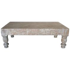 an old white coffee table with wooden legs