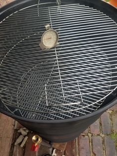 an outdoor grill is shown with the lid down and no burners on it's side