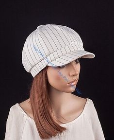 a mannequin head wearing a white hat with blue writing on it