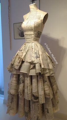 a dress made out of newspapers sitting on top of a table