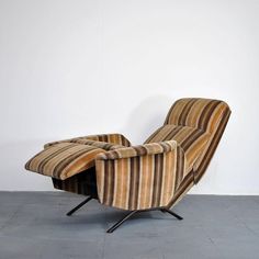 a striped chair sitting in front of a white wall