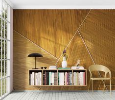 an empty room with a book shelf, chair and lamp on the floor in front of it