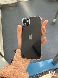 someone holding up an iphone in their hand