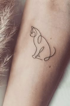 a small cat tattoo on the arm