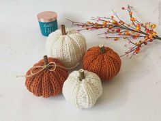 three knitted pumpkins sitting next to each other