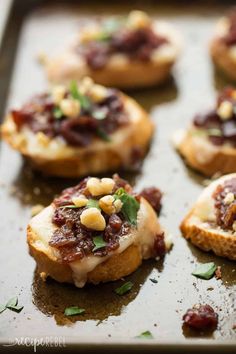 several small appetizers are sitting on a baking sheet and ready to be eaten