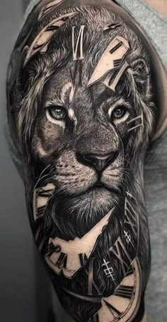 a man's arm with a lion and clock tattoo on his arm, it is black