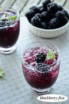 two glasses filled with blueberries and blackberries