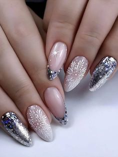 a woman's hands with white and silver nail polishes on their nails, decorated with snowflakes