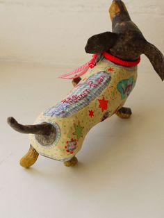 a toy dog is wearing a shirt and tie on it's back legs with its mouth open