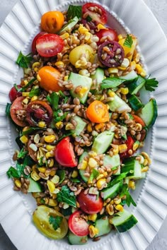 a white plate topped with a salad and lots of veggies on top of it