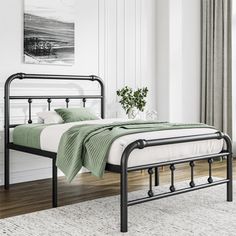 a black metal bed frame in a white bedroom