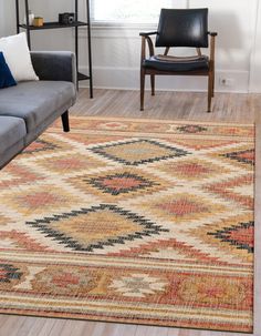 a living room with a couch, chair and rug