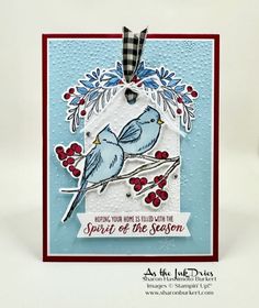 a card with two birds sitting on a branch and the words spirit of the season