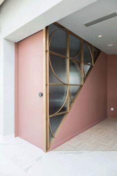 an open door in a room with pink walls