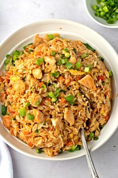 a white bowl filled with rice and vegetables