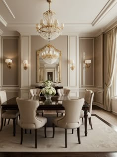 an elegant dining room with chandelier and table surrounded by beige upholstered chairs