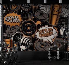 there are many gym equipment in this room with an orange and black wall behind it