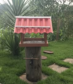 a tree stump with a water fountain in the middle