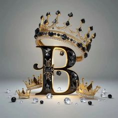 the letter b is made up of black and gold jewels, with a crown on top