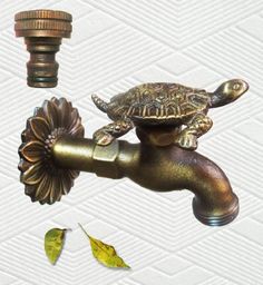 a bathroom sink faucet with a turtle on it's head and water running from the faucet