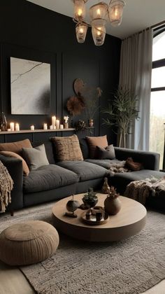 a living room filled with lots of furniture and candles on the wall above it's coffee table