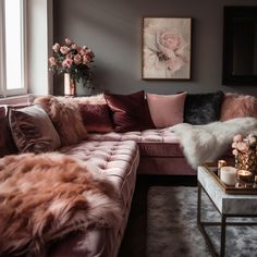 a living room filled with furniture and flowers