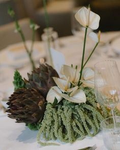 there is a pine cone and flowers on the table