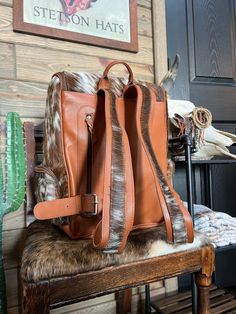 This backpack is HUGE!! it’s perfect for a diaper bag or your airport travel bag! It has a ton of room and so many pockets making this the perfect useful bag for traveling or making sure you have everything for your kiddos! Backpack measures approximately 10” x 16” x 16” Genuine cowhide 2 front pockets, side pocket on each side both inside and outside. Card slots & zipper pocket on the inside as well! LAST PICTURE IS FOR SIZE REFERENCE ON We show the EXACT hide here so you know what you’re getti Brown Backpack For Weekend Trips, Standard Backpack For Daily Use, Luxury Rectangular Backpack For Trip, Canvas Travel Backpack, Travel Backpack With Luggage Sleeve, Adjustable Strap Backpack For Weekend Trips, Standard Backpack For Travel, Weekend Trips Backpack With Adjustable Strap, Luxury Travel Tote Backpack