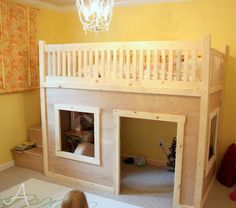 a child's bedroom with a loft bed and stairs on the bottom level, while a chandelier hangs from the ceiling