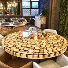 a table made out of wooden logs with chairs around it