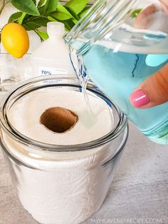 a person is pouring water into a jar filled with toilet paper and some lemons