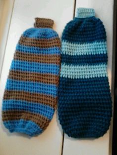 two crocheted mittens laying next to each other on top of a counter