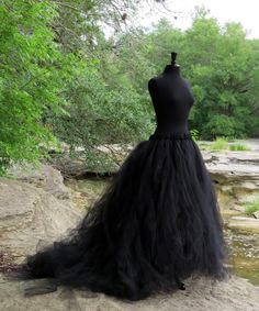 a black dress is sitting on top of a rock