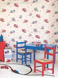 children's room with toys and wallpaper on the walls, including a table and chairs