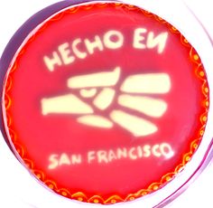 a close up of a red cake with white frosting on the top and san francisco written on it