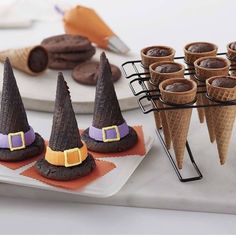 there are many desserts in cones on the table