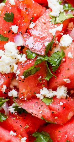 watermelon salad with feta cheese and basil on top, ready to be eaten