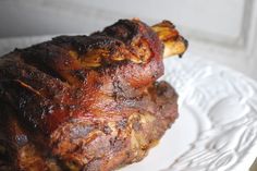 a piece of meat sitting on top of a white plate