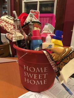 a bucket filled with lots of items sitting on top of a table