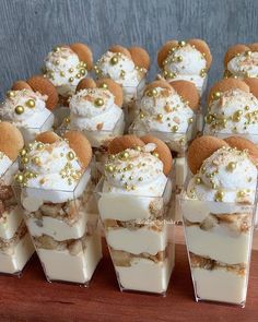 small desserts are arranged in clear containers on a table