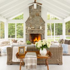 a living room filled with furniture and a fire place in the middle of a room