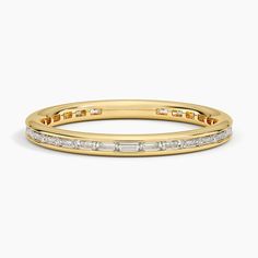 a yellow gold band with baguets and diamonds