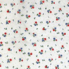 a white fabric with red, blue and green flowers on it's side is shown