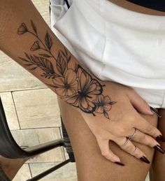 a close up of a person's leg with flowers on it